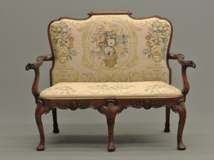 Chippendale Style Settee: Mahogany Chippendale style needlepoint upholstered settee, arms have carved eagles heads. 48" x 22" x 42" Ht.