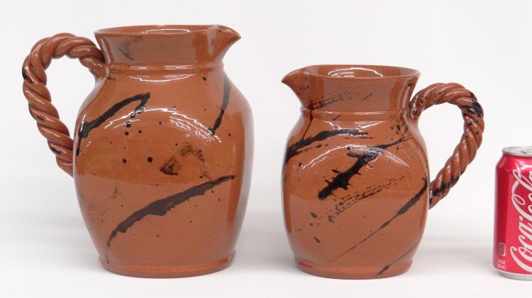 Lester Breininger Lot: Lot two signed Lester Breininger redware pitchers. Includes "May 13, 1996" (8" Ht.), and "May 14, 1996" (9 3/4" Ht., rim chips).