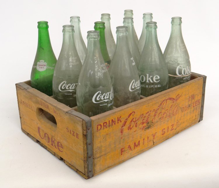 Coca Cola Crate: Vintage Coca Cola crate with various (10) Coca Cola bottles and (2) Ginger Ale bottles.