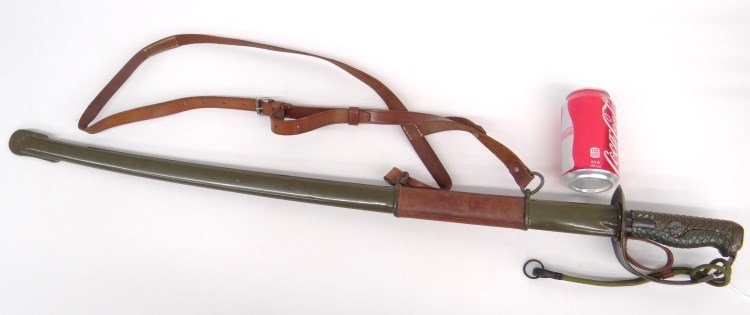 Replica Sword: Replica military cavalry style sword, curved steel blade, metal grip, metal scabbard, leather belt. 38" L.