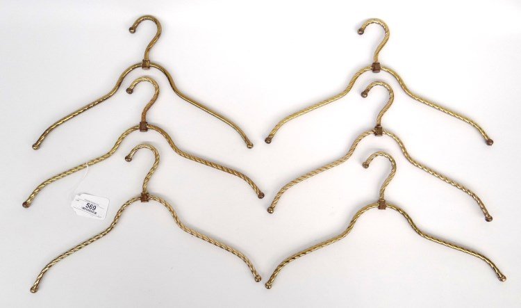Brass Hangers: Set of (6) brass coat hangers.