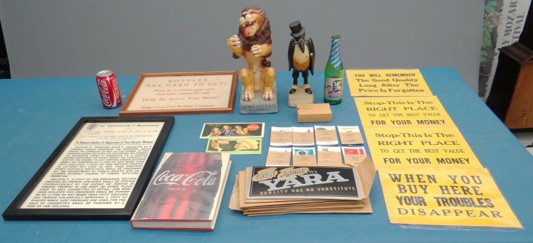 Misc. Lot: Misc. advertising Coke and other items including: Coca-Cola book, "Lowenbrau" lion, "Old Crow" figure, Coke "bottles are hard to get!" sign, (4) store slogan signs, Massachusetts "cigarette" sign, pac