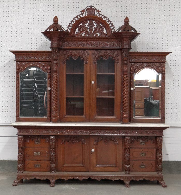 Monumental Wall Cabinet: Monumental two part carved mahogany marble top wall cabinet. Top has carved cornice, two center doors flanked by mirrored doors, base with two center doors flanked by banks of four drawers. Comes apar