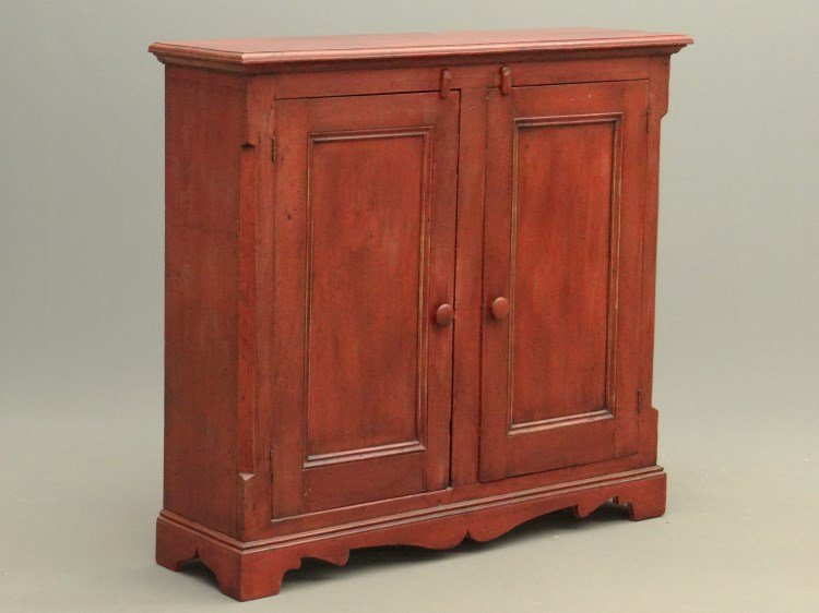 19th c. Quebecois Cupboard: 19th c. Quebecois two door cupboard, painted later red over original red. 50 1/2" x 14 1/2" (at top cornice) x 46 1/2" Ht..