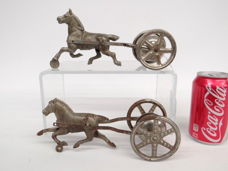 Toy Lot: Lot (2) C. 1900 - 1910 horse drawn "Gong Bell Toy Mfg. Co." Easthampton Conn. (5 spoke wheel 2 7/8" D., 9 3/8" L., 4 3/8" Ht., 3 1/4' W.), (6 spoke wheel 2 7/8" D., 9 1/8" L., 3 1/2" Ht., 3 3/8" W.).