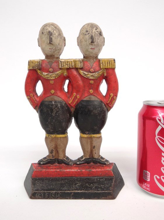 Doorstop: Doorstop of footmen. A smaller, rarer of two sizes produced, Hubley, Lancaster, PA, C. 1920, designed by Anne Fish, marked "Fish" on front, "272" on backside. Original paint. 9" Ht.