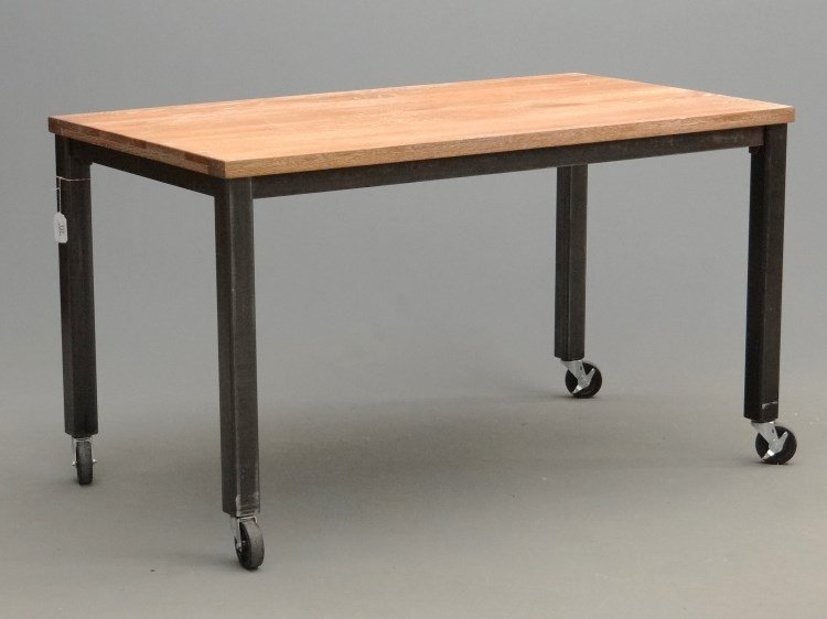 Industrial Table: Industrial rolling table. Wooden top with metal base raised on casters. 34 1/2"x 64 1/2" x 34 1/2" Ht.