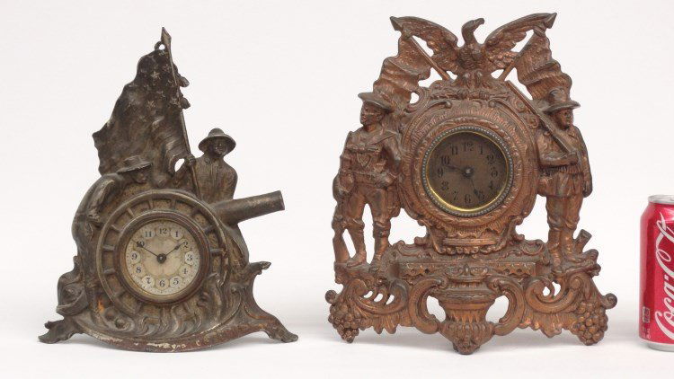 Cast Iron Patriotic Clocks: Lot of (2) C. 1900's cast iron Patriotic clocks including one marked "Volunteers", (10 1/2" Ht.), and Spanish American War Army/Navy C. 1900, (11" Ht.).