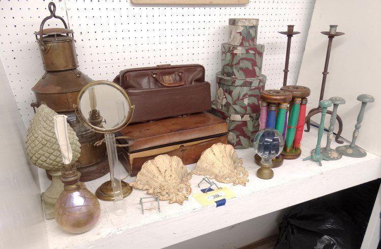 Misc. Lot: Misc. lot including French wig stands, pair cast iron wall pockets, sewing spools, brass shaving mirror, brass and glass ornament, (4) nesting boxes, stone finial, art glass oil lamp marked "Roland",