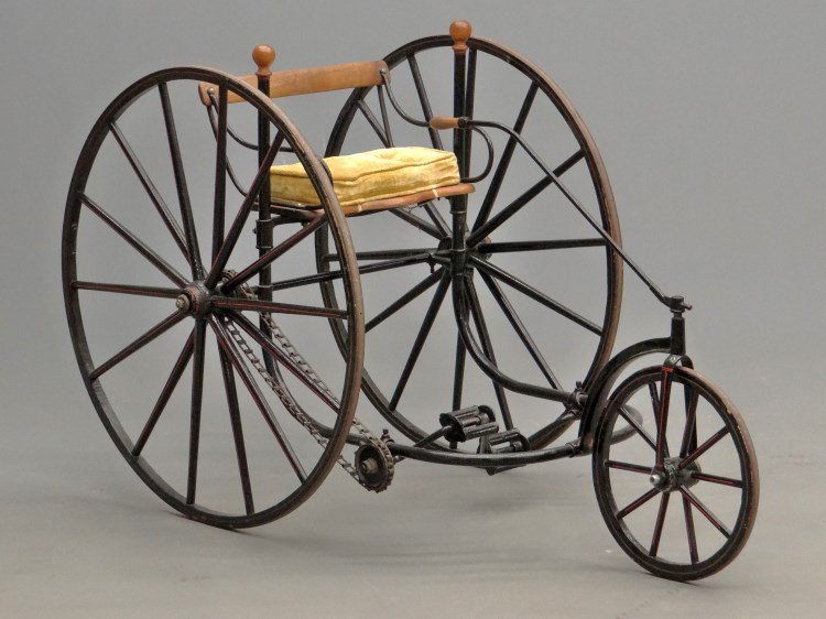 Adult Tiller Tricycle: 19th c. Adult Tiller tricycle, ex Gary Woodward collection. 14" Front, 32" rear wooden spoked wheels with iron strap tires, older restoration, good paint and pin stripes. A well appointed restoration.