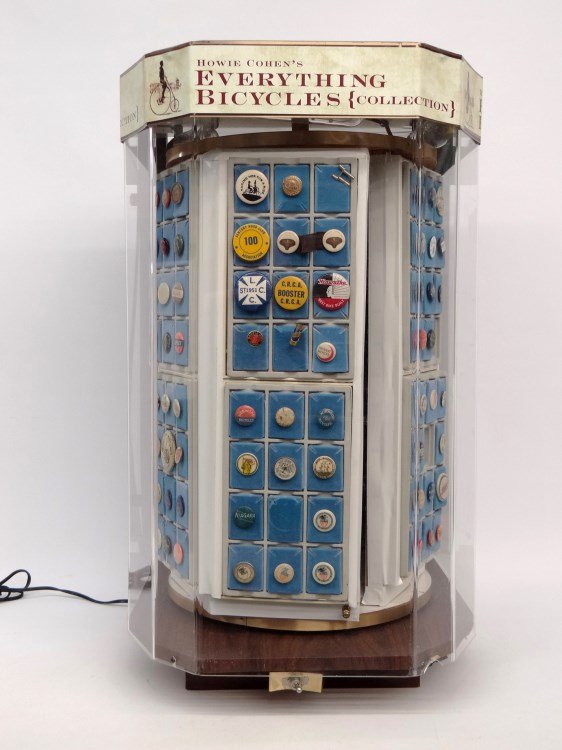 Collection Of Early Bicycle Pinbacks: Collection of (136) early bicycle pins in custom revolving case. Names include Rose Bicycles, The Stearns, Sylph, Sterling, Orient, Puritan, Pierce, Niagara, Crescent, Keating, Halladay, Victor, White