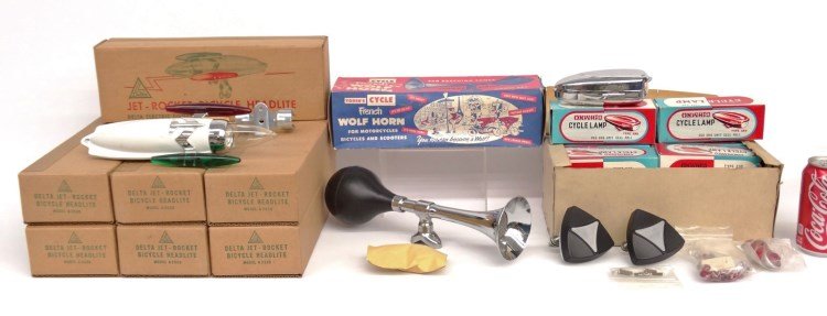 NOS Delta and Misc. Accessories Lot: (7) NOS Delta Jet Rocket headlites, (12) NOS Onward cycle lamps type 230 (1 cell), NOS reflectors and pedel jewels, NOS Yoder's "French Wolf horn" model 485. All NOS mint in box.