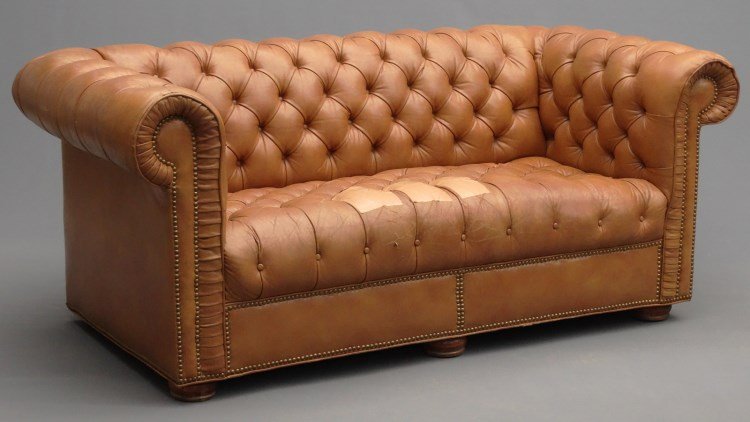 Leather Chesterfield Sofa: Leather Chesterfield sofa. 68" x 34" x 30" Ht. Some damage to seat.