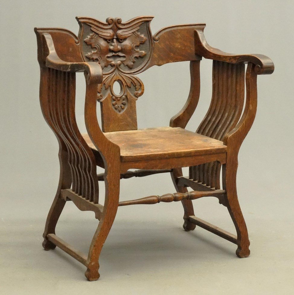 Victorian Oak Savonarola Chair: Victorian oak Savonarola chair with North Wind God carved back rest. 17" seat Ht., 35" overall Ht.