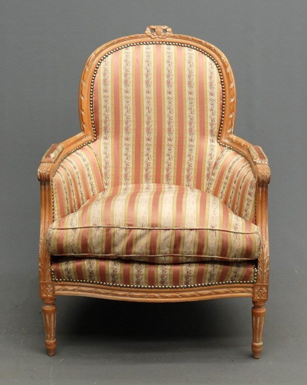French Provincial Bergere: French Provincial upholstered Bergere chair with carved frame. 17" seat Ht., 36" overall Ht.