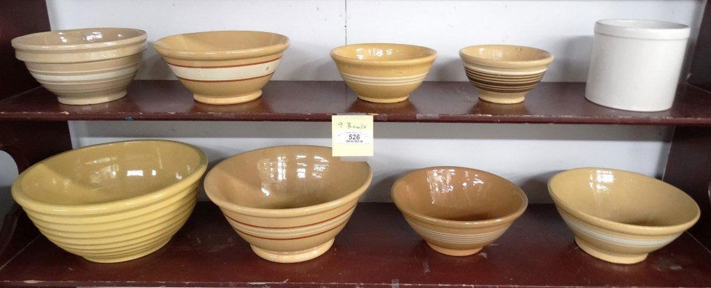 Yelloware Bowls: Lot (9) pieces including yelloware kitchen bowls and crock. 7" to 14" D.