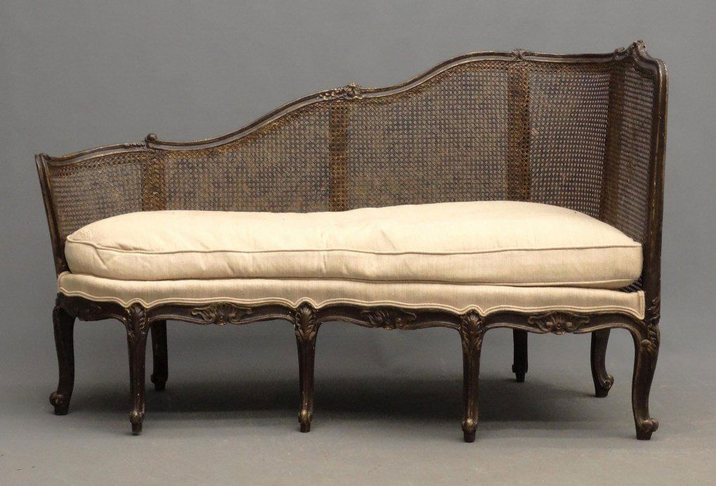 French Caned Chaise: Early French painted and carved caned chaise with cushion. 59" x 31" x 37" Ht.