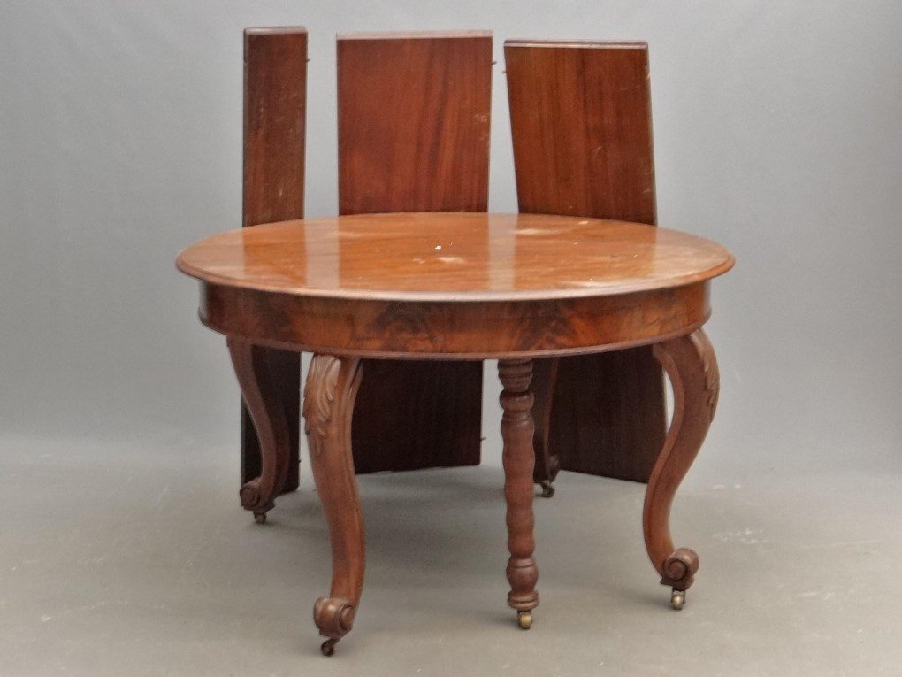 Mahogany Dining Table: C. 1900's round mahogany carved leg dining table with (6) leaves. Leaves 7" to 16" L.