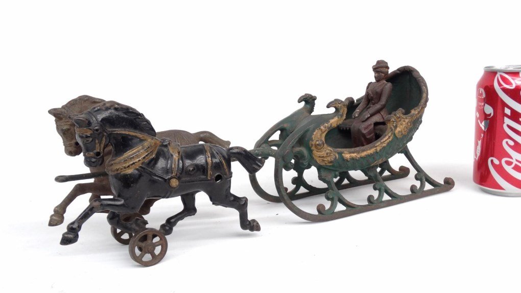 Hubley Cast Iron Woman In Sled Toy: C. 1906 Hubley cast iron woman in sled toy. 15" L.