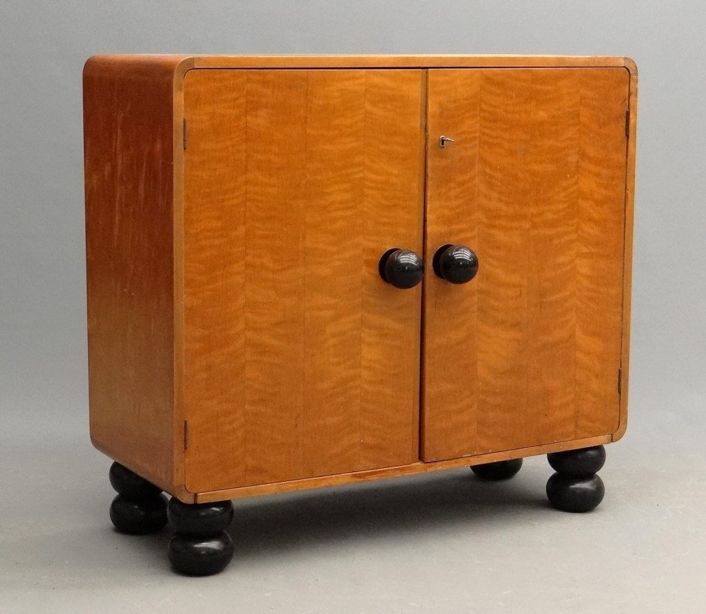 Art Deco Cabinet: Art Deco two door cabinet with bun suppressed ball feet. Ebonized knobs and feet. 41 1/2" x 17 3/4" x 38 1/2" Ht..