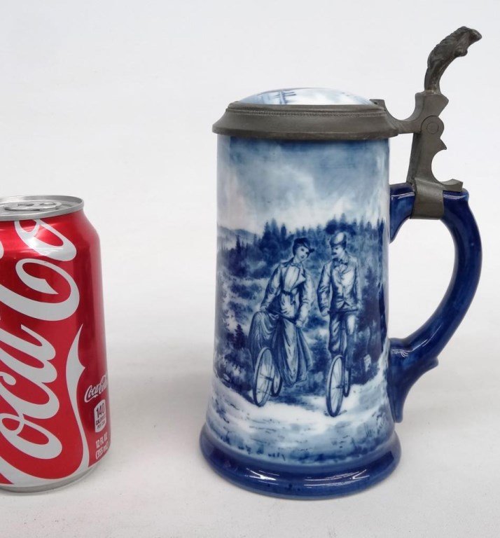 Stein: Stein with riders on safety bicycles. Sailing ship on lid. 8 1/2" Ht.. Good condition. Provenance: Richard Roy Estate.