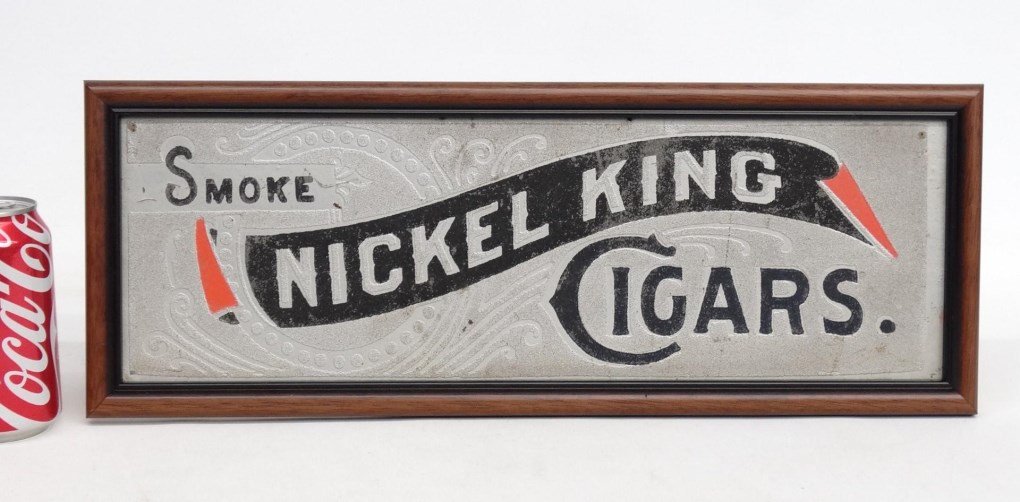 Trade Sign: C. 1900's trade sign. Sand paint on panel "Smoke/Nickel King/Cigars". Frame 7" x 19".
