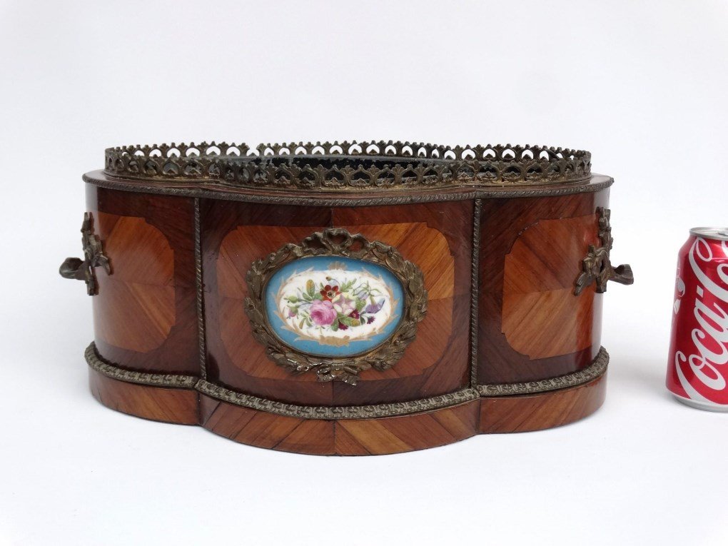French Planter: French shaped planter. Brass mounted with pierced gallery. Also has Mintons type porcelain medallion. Tin insert. 17" x 10" x 7 1/2" Ht..
