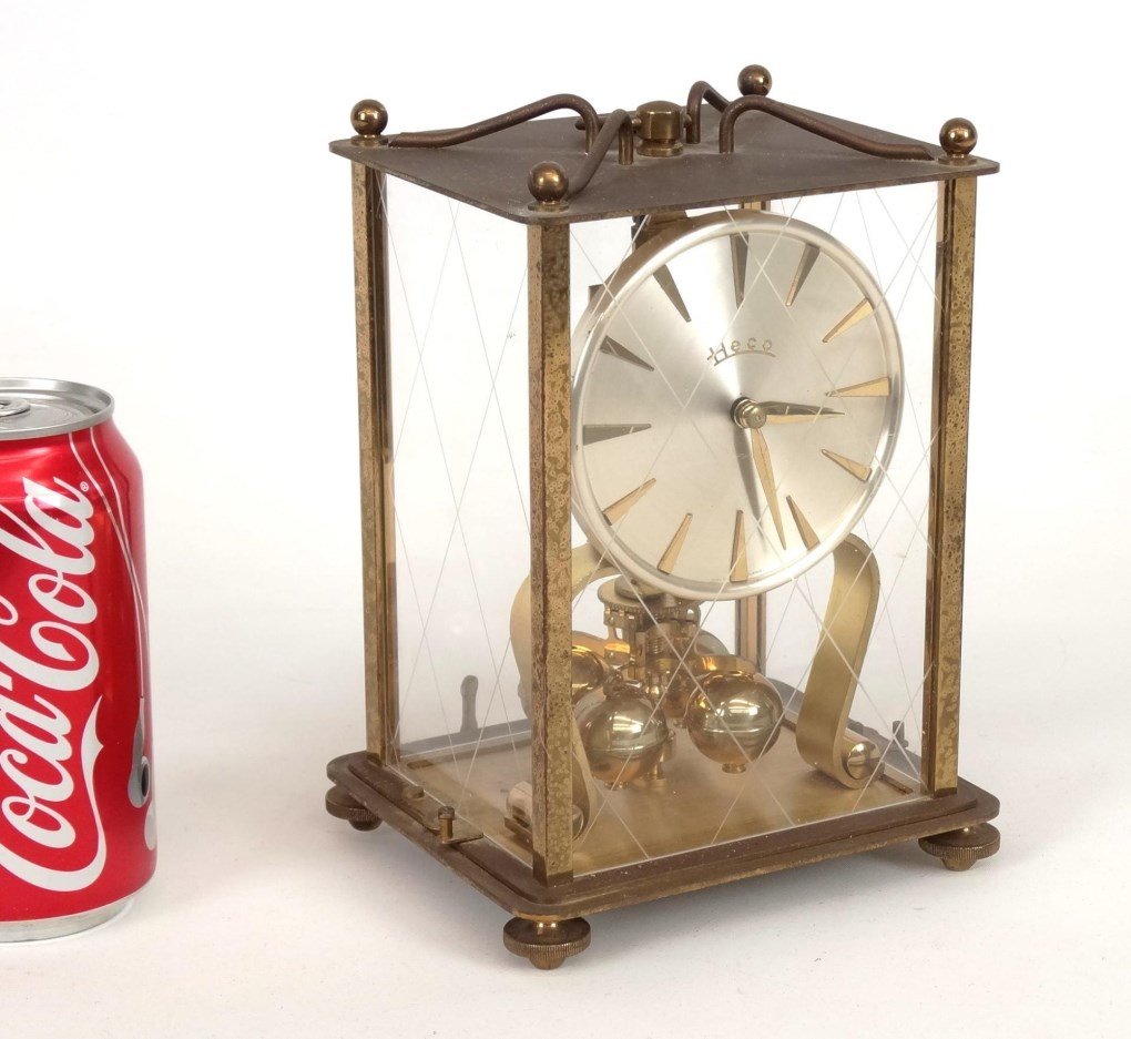 Mantle Clock: Heco brass and glass mantle clock. 5" x 4" x 7 1/2" Ht..