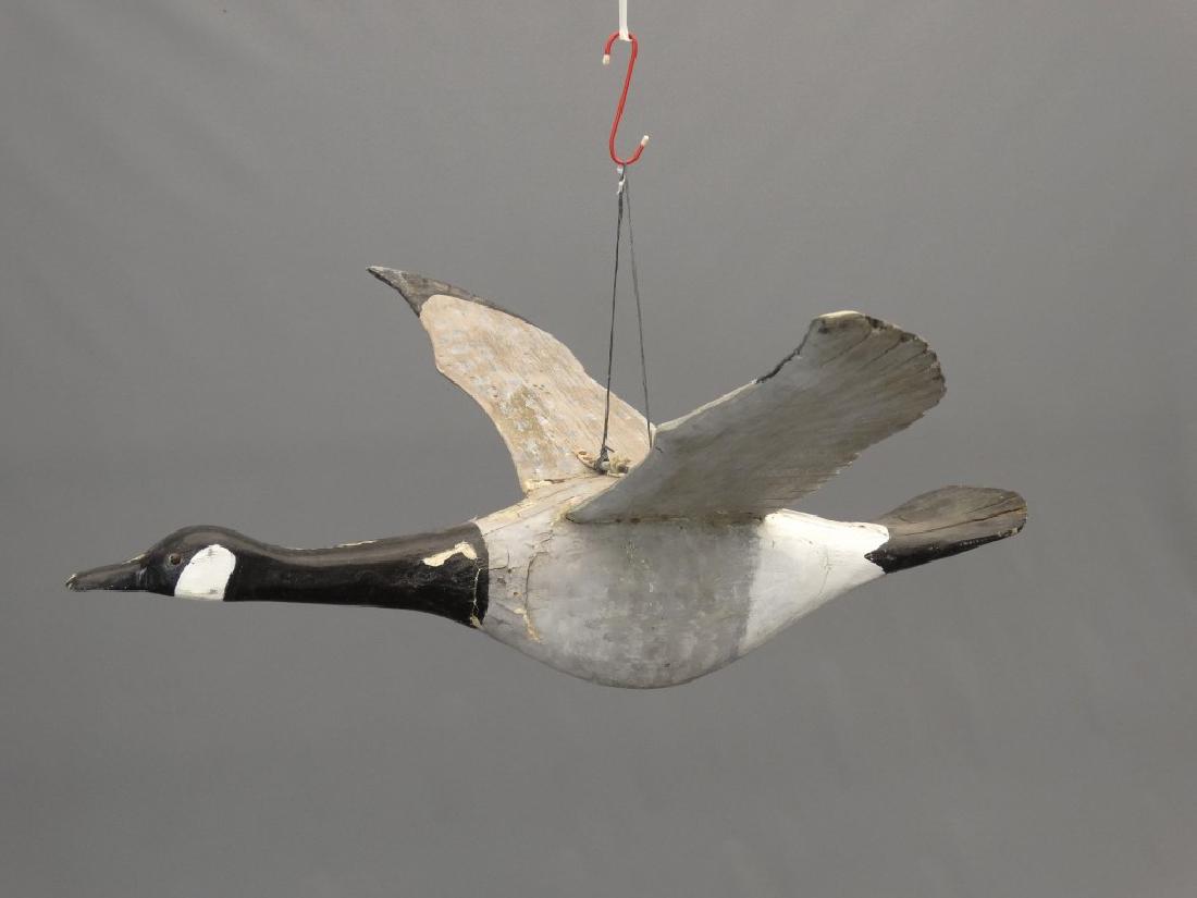 Carved Flying Goose: Early carved and painted wooden flying goose. 52" Wing span, 32" L..