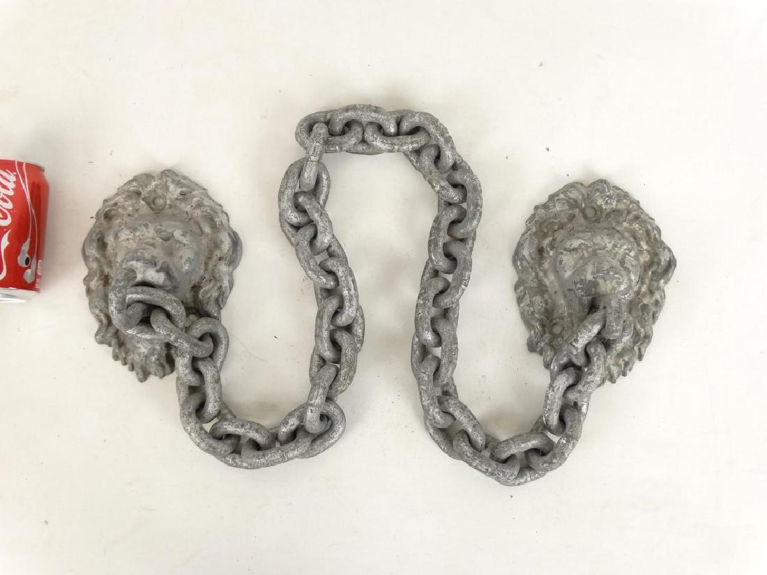 Iron Gate Chain: Early cast iron gate chain with lion heads. 51" W..
