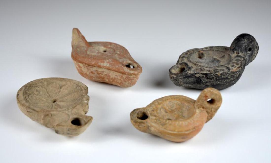 FOUR ANCIENT ROMAN OIL LAMPS (1 of 4)
