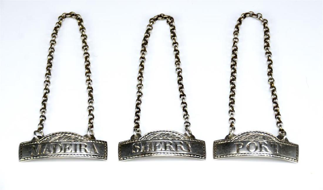 GEORGE III SILVER WINE LABELS: Of Sherry, Port and Madeira. The bottle tags each with period double looped chain, bright cut and pierced. Makers mark of Hester Bateman and a lion passant, no date or city mark. English ca.1780. W. 1