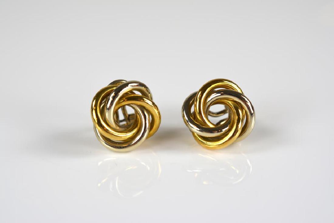 Pair of 18k gold knot twist clip earrings: In two tone gold, backed by omega clips. Stamped 18k, 10.6g.