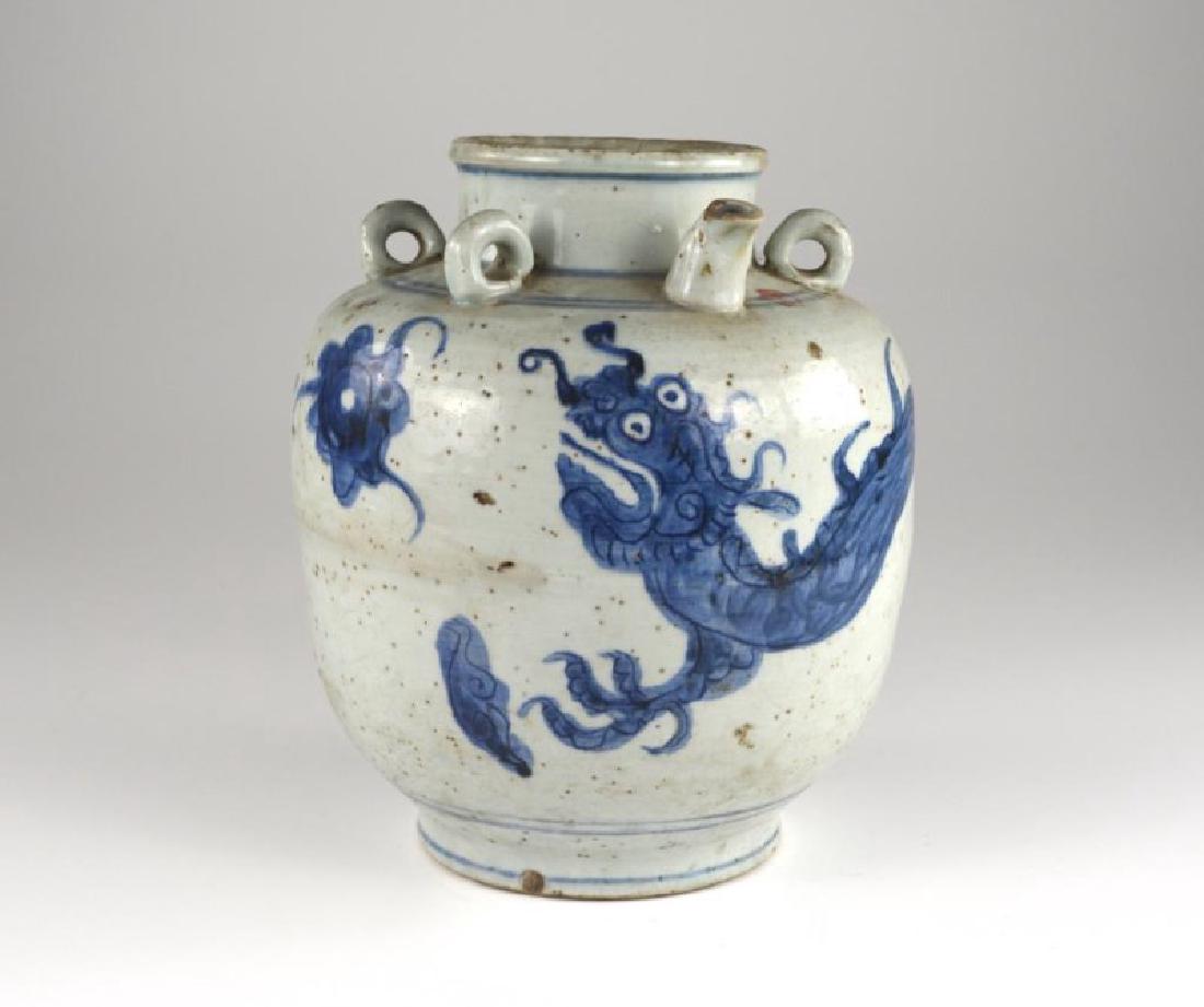 CHINESE MING DYNASTY BLUE & WHITE DRAGON WINE EWER: Should with four ring handles and a spout. Body painted with a flying dragon chasing a flaming pearl. H. 28cm (10 3/4 in.)