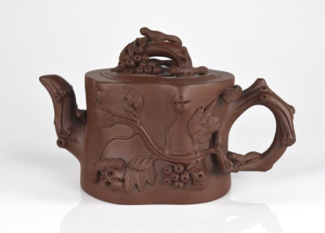 YIXING POTTERY TEAPOT WITH NI SHUNSHENG SEAL: Tree trunk imitation with relief decoration of branches and squirrels. H. 10cm (4 in.)