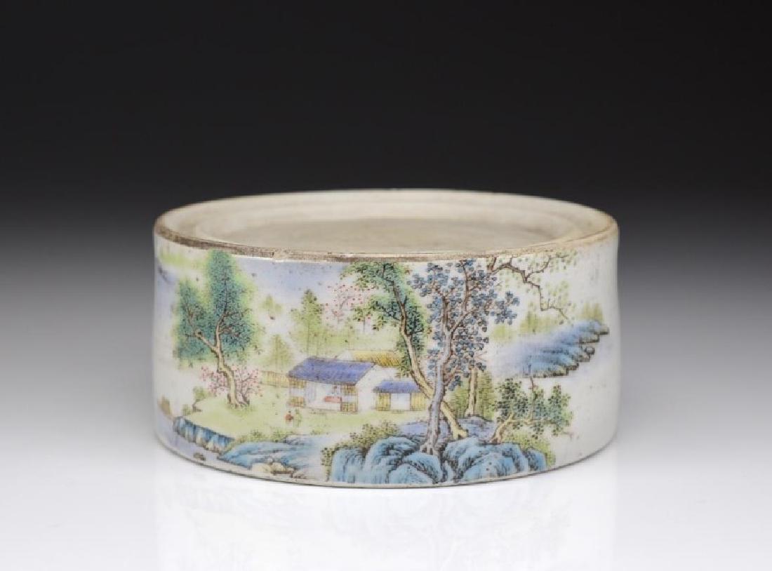 CHINESE REPUBLICAN FAMILLE ROSE PORCELAIN INKSTONE: Painted with village landscape on one side, from Zhu Shan, and dated to the eighth year of the Republican period (1919). Dia. 14cm (5 1/2 in.) H. 6.5cm (2 5/8 in.)