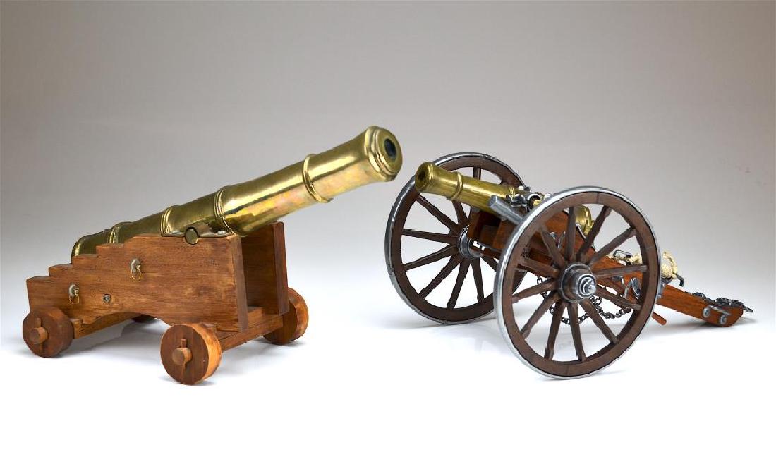 Two miniature brass signal cannons