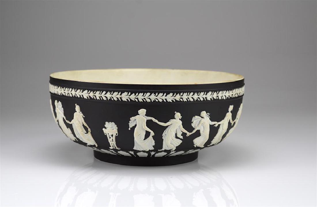 Wedgwood black basalt Jasperware center bowl: Dancing Hours. Incised Wedgwood, Made in England, 70 (1970) to base. Dia. 25.4 cm (10 in.)