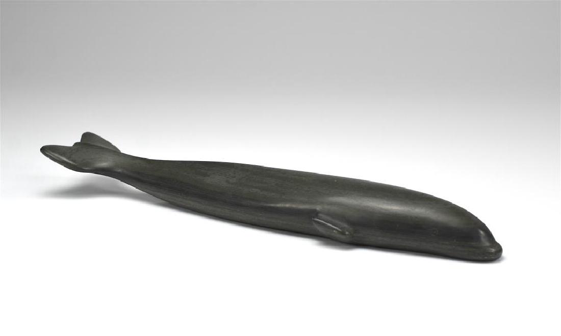 JOE EMIQUTAILAQ (1918 - ): Beluga whale.Grey stone Inuit sculpture.Signed in syllabics to base with disc number E985. Sanikiluaq, Belcher Islands.L of whale: 13 1/8 in. (33.3 cm)