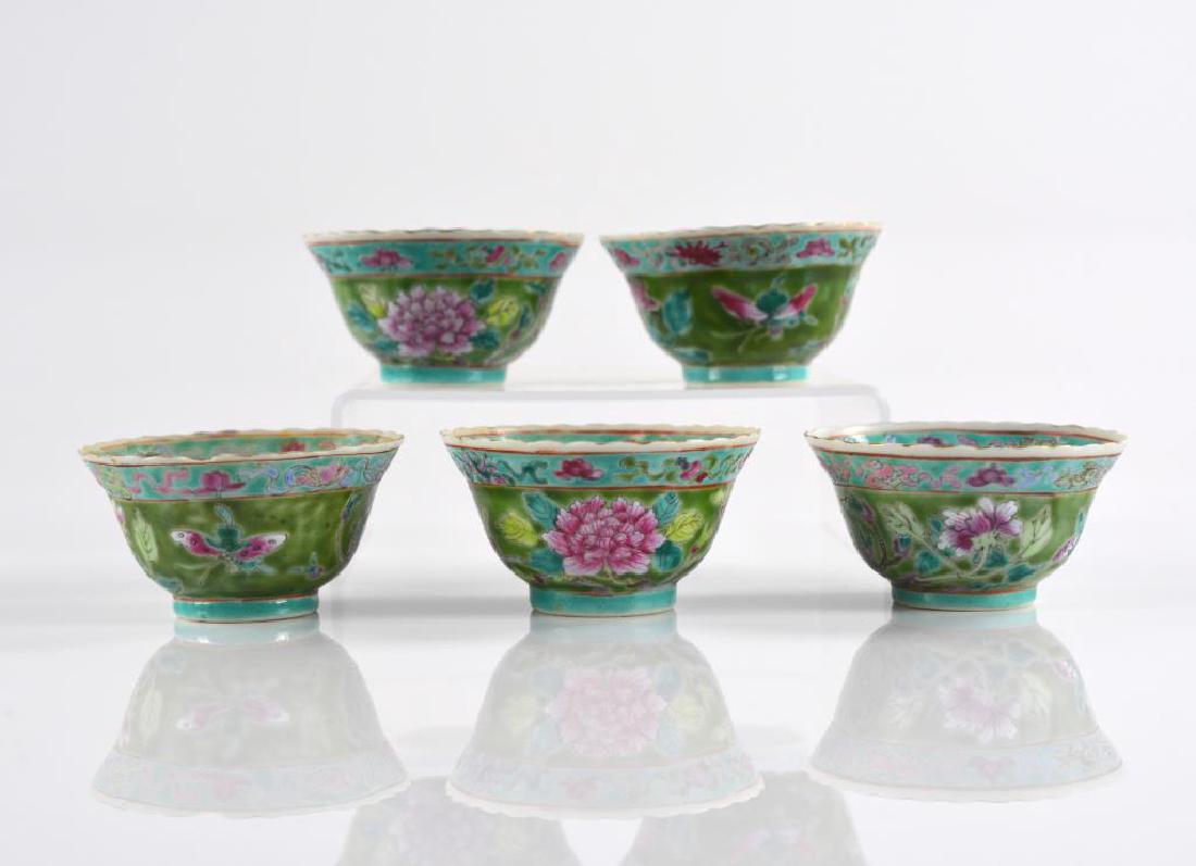 FIVE CHINESE FAMILLE ROSE PORCELAIN CUPS: Painted on turquoise and green ground with florals and Buddhist emblems. Base with iron red mark, 19th C. Dia. 8.5cm (3 3/8 in.)