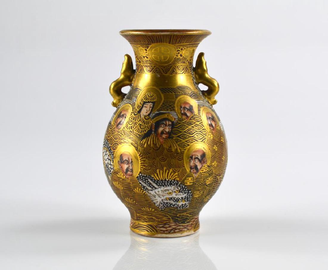 JAPANESE SATSUMA POTTERY VASE: Neck with Shimazu family mark on each side. Body painted with figures and a dragon, gilt fish handles. Mark rubbed to base. H. 12cm (4 3/4 in.)