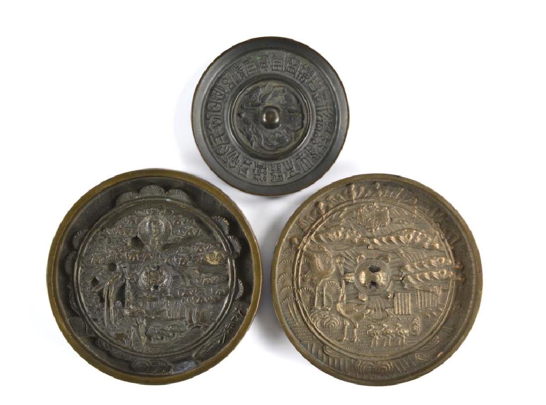 THREE CHINESE AND JAPANESE BRONZE HAND MIRRORS (1 of 2)