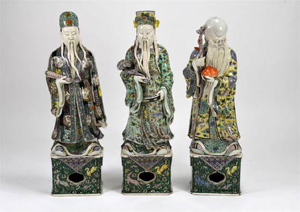 CHINESE FAMILLE VERTE FU LU SHOU PORCELAIN FIGURES: Each figure standing on a square pedestal painted wih textile imitation and sea horses. Each finely painted with black, turquoise, and yellow ground clothing holding scroll, lingzhi ruyi, and peaches.