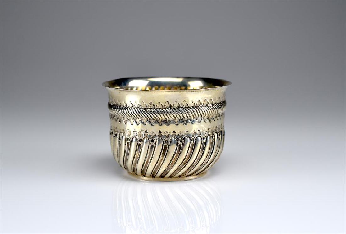 Victorian silver sugar bowl w/ coin insert: Decorated with swirled gadroon band and half-fluted body. With a 1780 Queen Anne coin inserted into the bottom. London, 1883. Charles Stuart Harris. 154g. tw. H. 7.9 cm (3 1/8 in.)