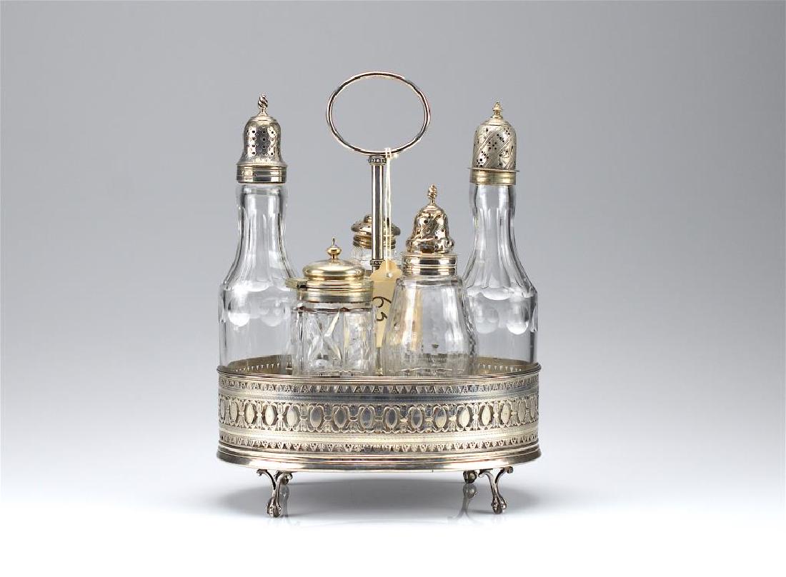 George IV silver cruet stand: George Gray, London, 1829 with six various cut glass bottles
