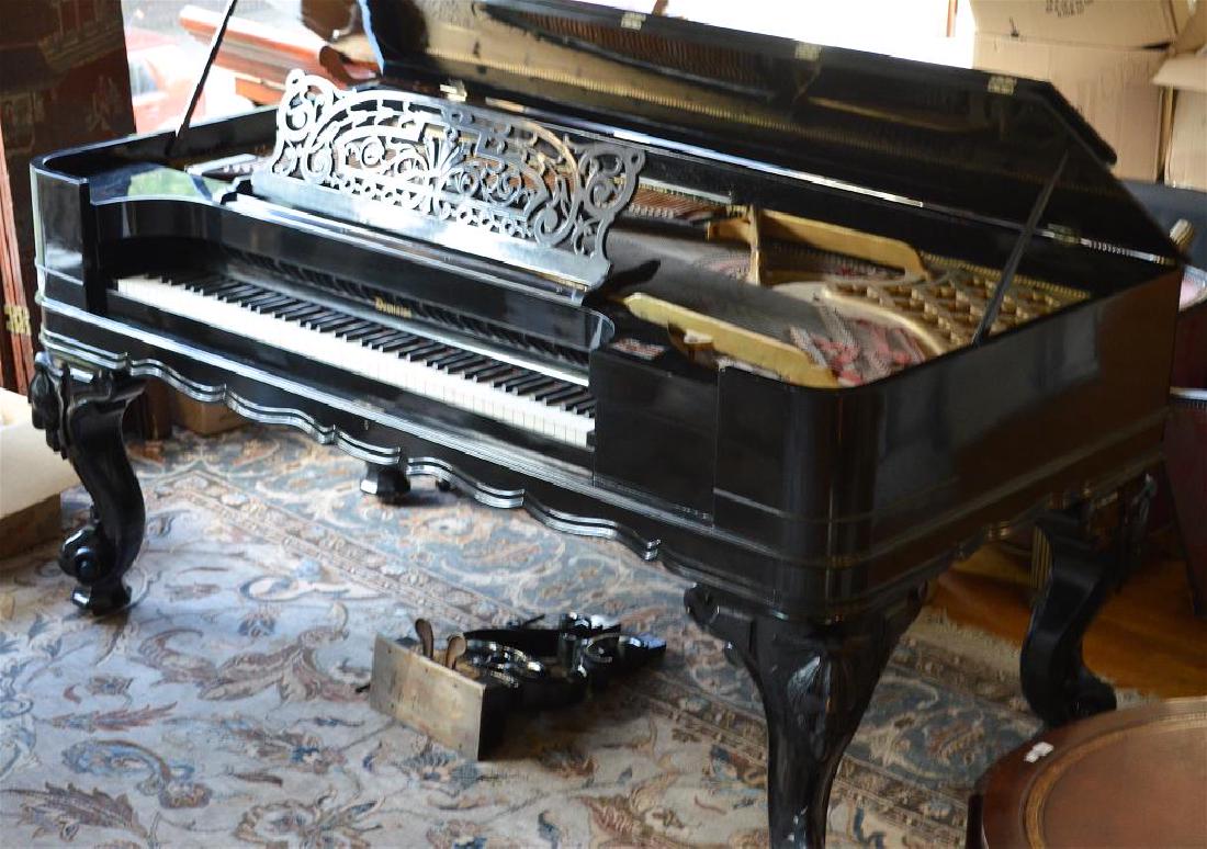 Rectangular Dominion baby grand piano: In black lacquer with with heavy Victorian legs.