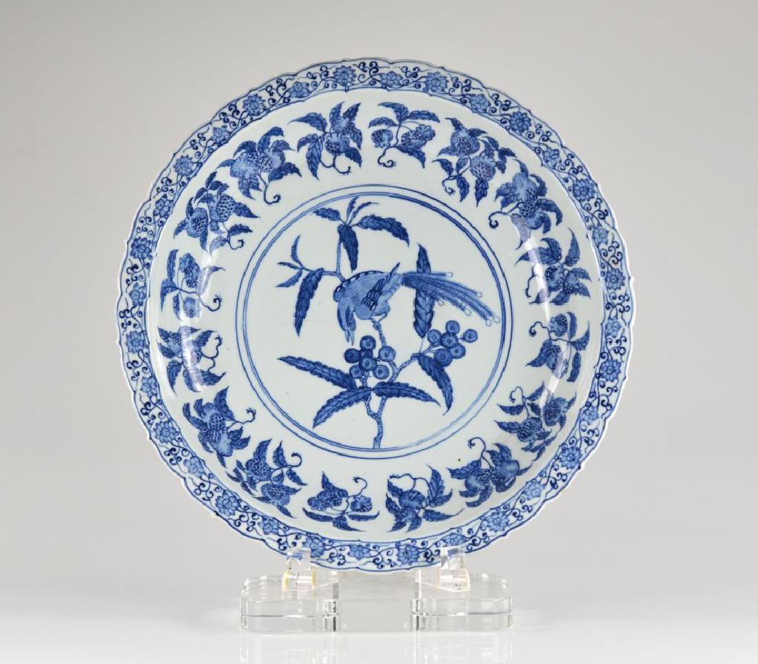 Chinese blue and white porcelain charger: contemporary in the Ming dynasty manner. Decorated with birds and peach blossom in the center. Size: Dia. 51.5cm (20.5 in.)