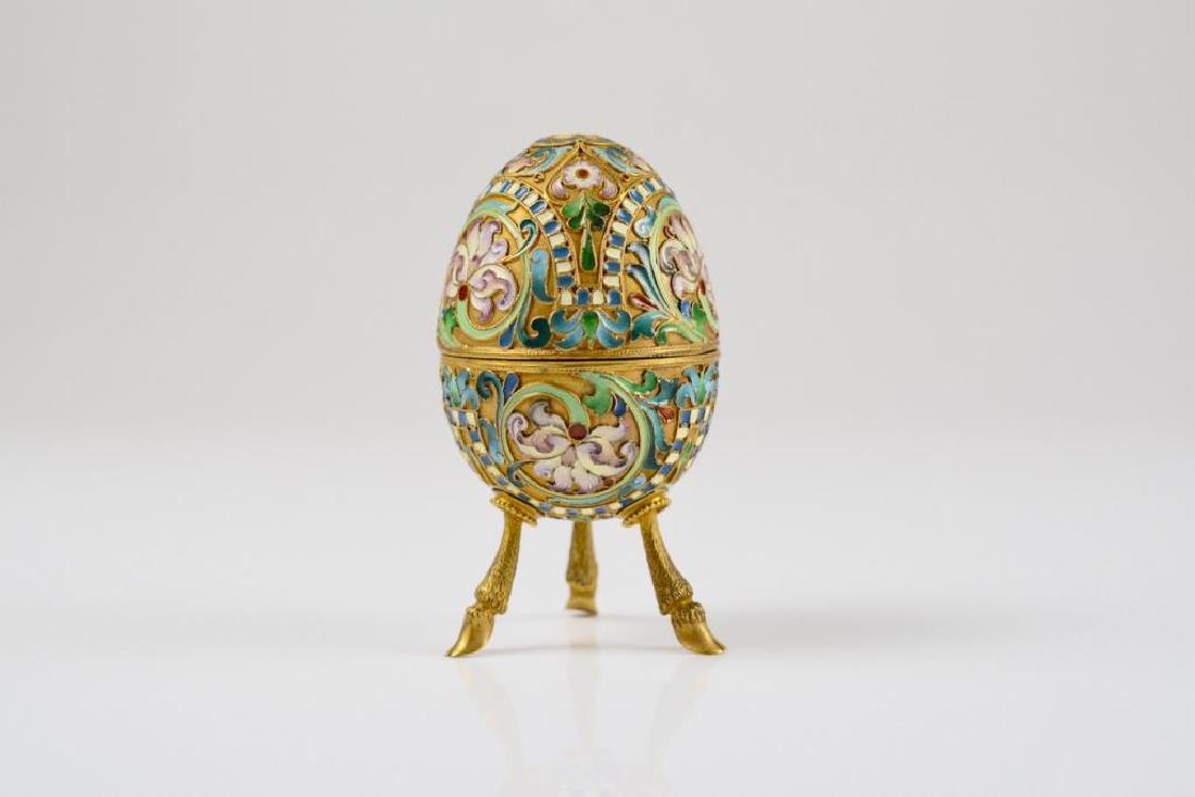 Gilt silver & enamel egg: Gilt silver & enamel egg Russian, raised on three hoof feet with foliate and floral enamel decoration. marks worn, 99g
