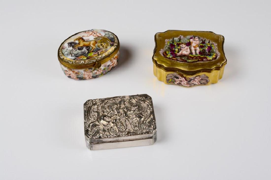 Three decorative boxes: Three decorative boxes A silver plated box with a Classical figural repousse scene to the lid. monogrammed. Together with two Naples Capodimonte porcelain boxes, both marked to base. All with hinged l