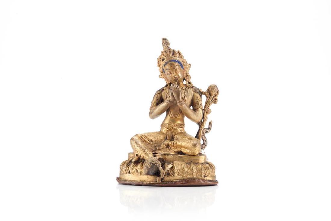 TIBETAN GILT BRONZE SEATED TARA FIGURE: Seated on a lotus pedestal, with hands in dharmachakra mudra position. Hair and facial features painted black, red and blue. H. 17cm (6 3/4 in.)